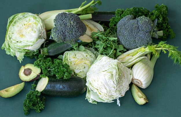 Fresh vegetables and greens on a green background