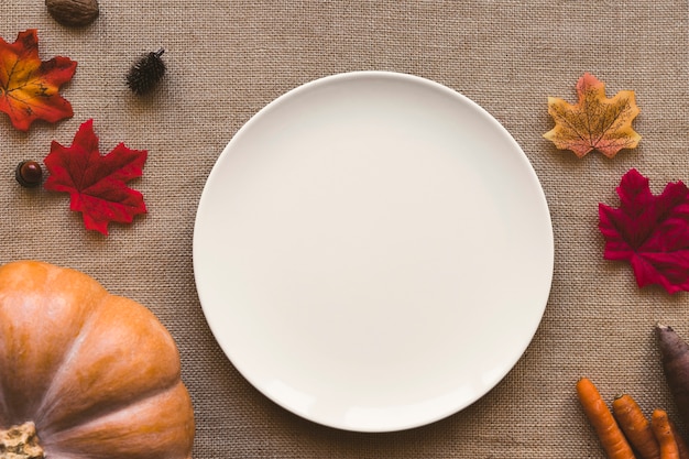 Fresh vegetables and leaves near plate