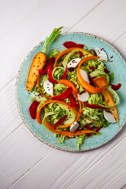 Fresh vegetables salad with carrot, greens and mushrooms