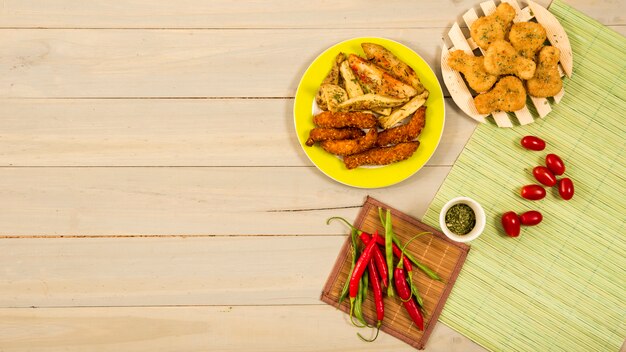 구운 닭고기와 감자 근처의 신선한 야채와 향신료