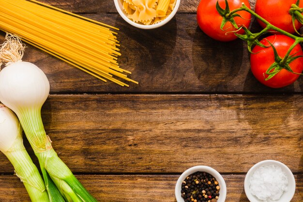 Fresh vegetables and spices near pasta