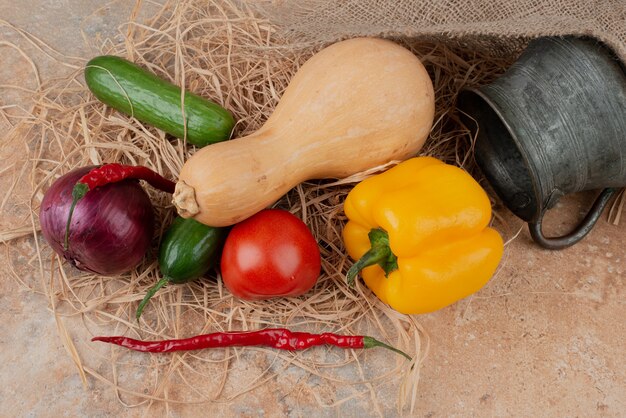 Fresh vegetables with ancient kettle on marble