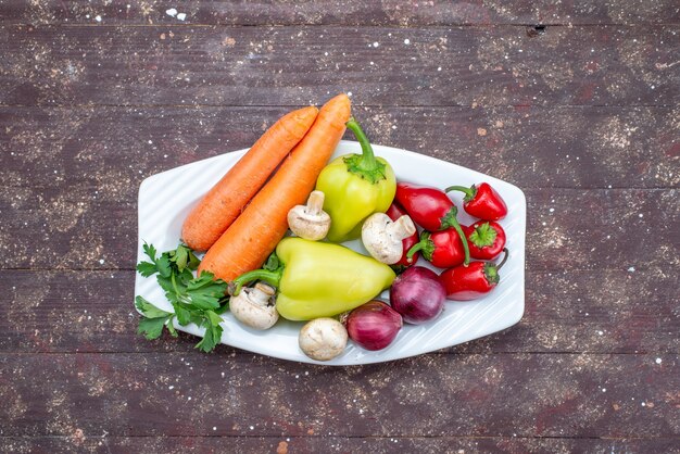 fresh vegetables with mushrooms inside plate on brown desk, vegetable food meal mushroom