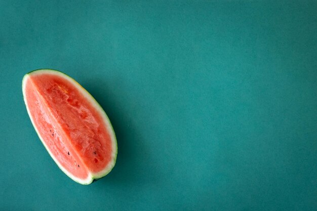 Fresh watermelon on blue background isolated flat lay