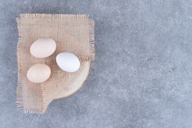 Fresh white chicken eggs on a marble surface