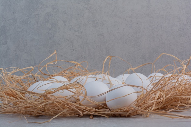 Free photo fresh white eggs on marble background.