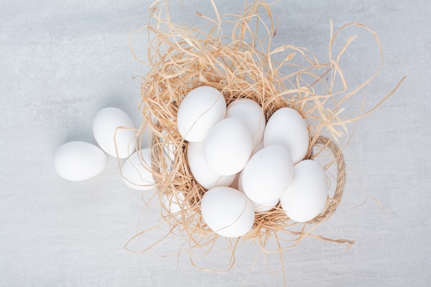 Free photo fresh white eggs on marble background.