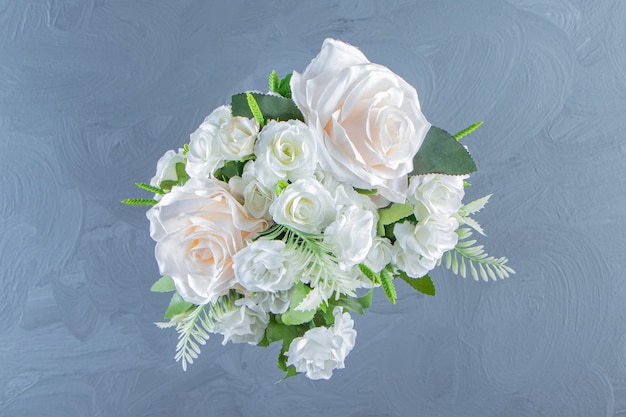 Fresh white flowers in a vase, on the marble table.