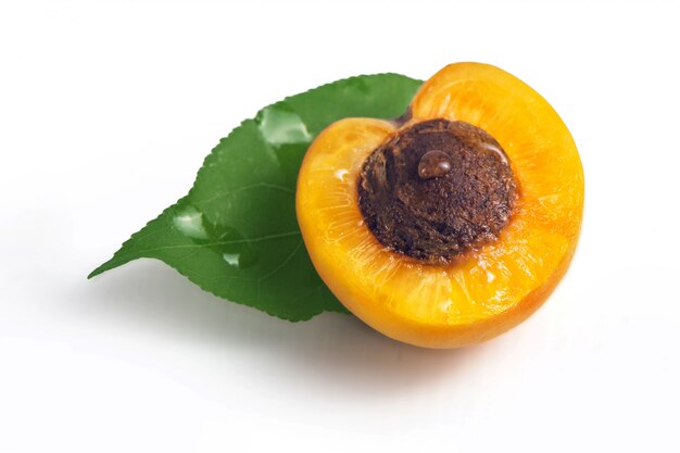 Fresh yellow apricots with green leaf