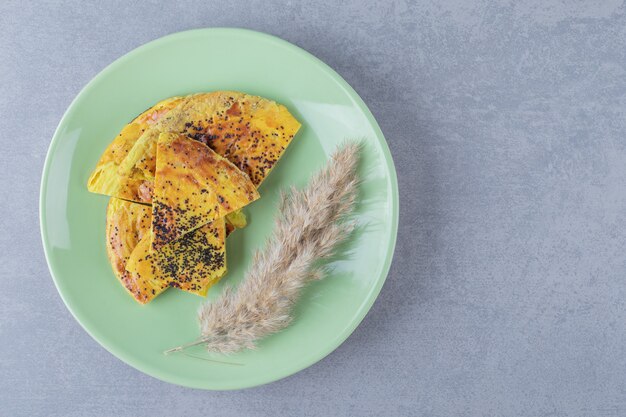 Fresh yellow homemade cookie on green plate