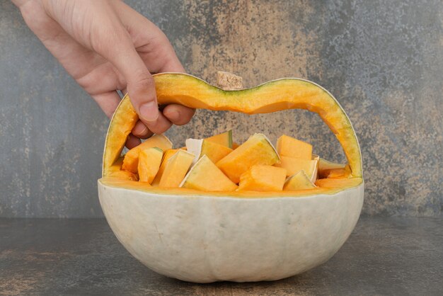 Fresh yellow pumpkin on marble surface