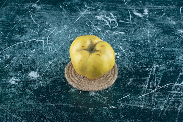 Fresh yellow quince on marble table. 