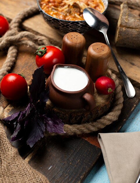 Fresh yogurt in pottery jar.