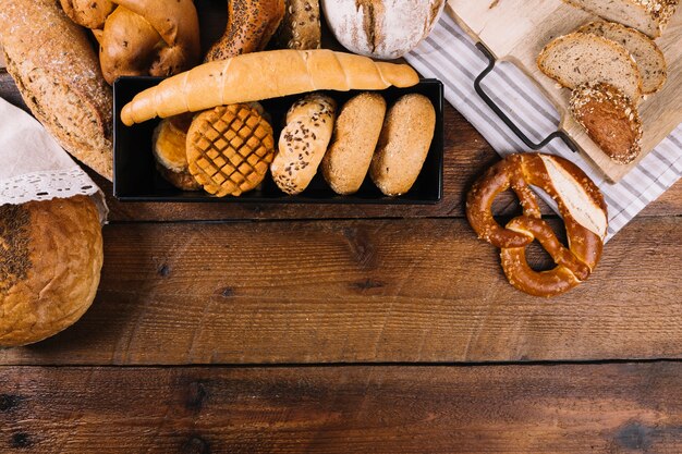Freshly baked bread on wooden textured background
