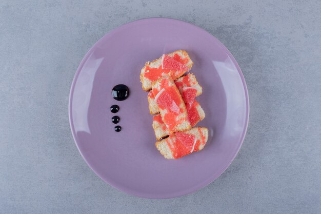 Freshly baked cake with grapefruit on purple plate