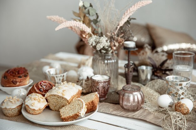 Freshly baked homemade cakes on a festive Easter table. Home serving hygge style.