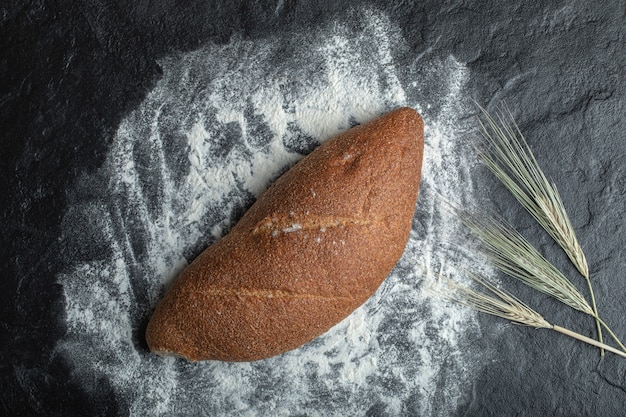 Freshly baked rye bread on black background
