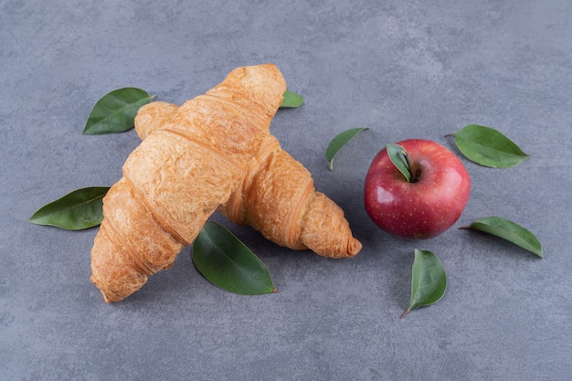 Freshly baked two croissant and organic red apple