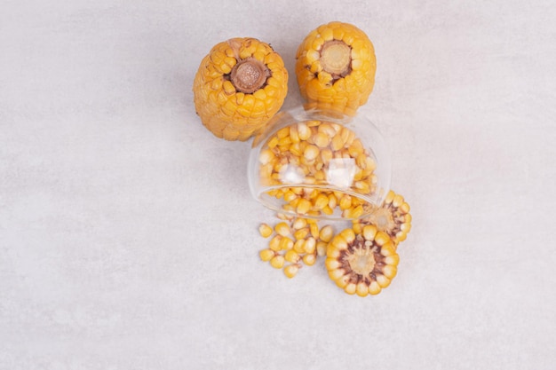 Free photo freshly boiled corns on white table.