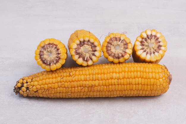 Freshly boiled corns on white.