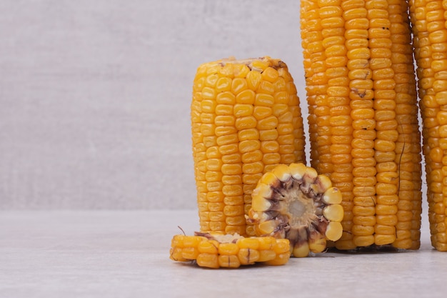 Freshly boiled corns on white.