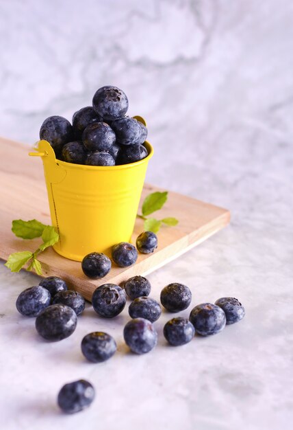 Freshly picked blueberries in yellow can