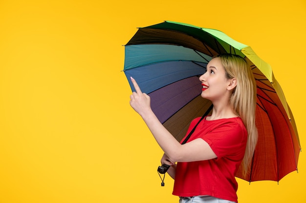 Frevo cute blonde girl celebrating brazilian festival holding umbrella and pointing up