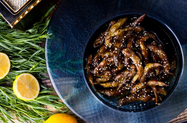 Fried anchovies with lemon and rosemary.