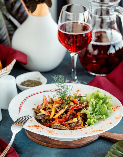 Fried beef salad  with colorful bell peppers cucumber pickles corn and herbs