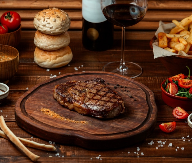 Fried beef steak on wooden board