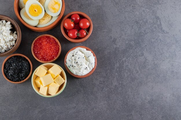 Fried bread with boiled eggs and red fresh cherry tomatoes . 