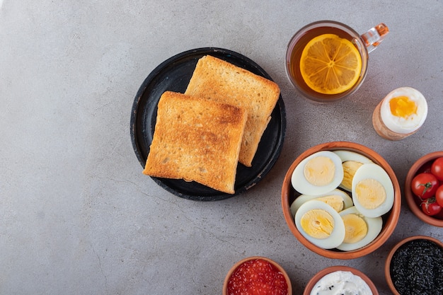 Fried bread with a cup of black tea and boiled eggs . 