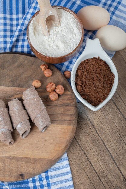 Fried caucasian mutaki cookies on a wooden board with cinnamon powder.