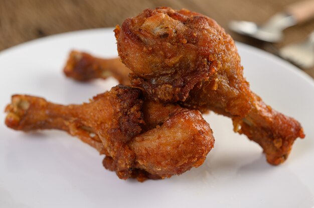 Fried chicken legs on a white plate