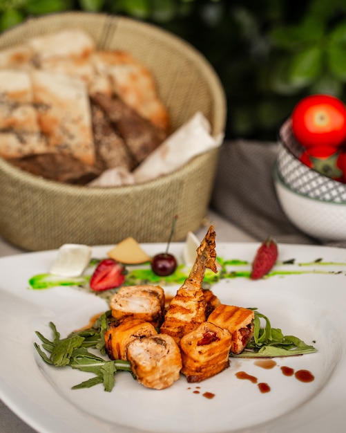 Free photo fried chicken roulets with vegetables in the plate