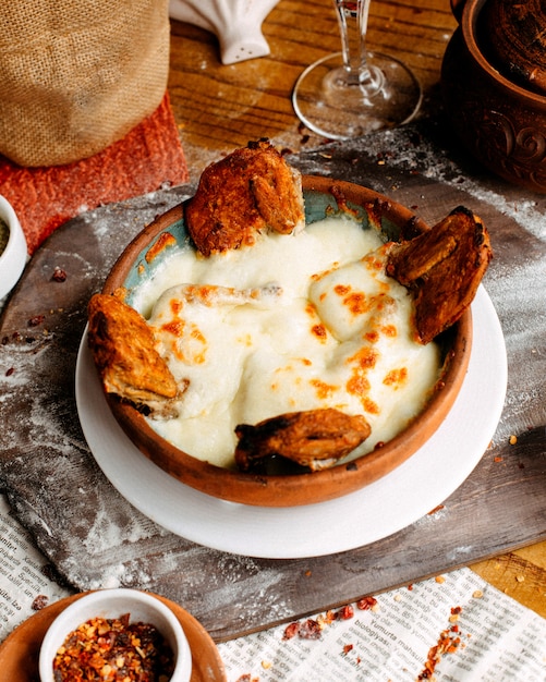 Fried chicken under sauce on the table