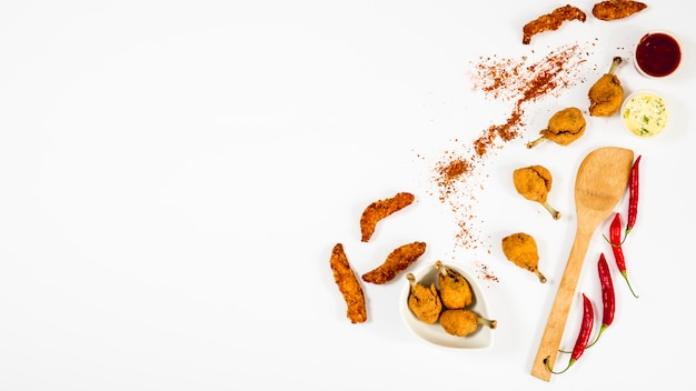 Fried chicken and spices around spatula