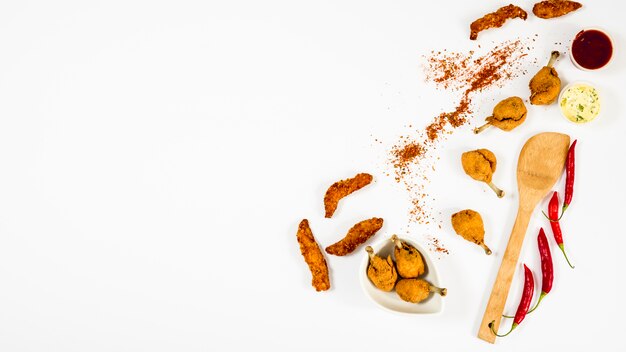 Fried chicken and spices around spatula