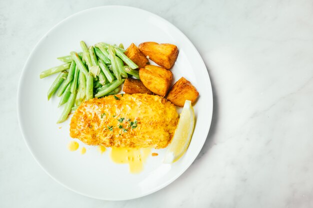 Fried chicken steak with lemon and vegetable