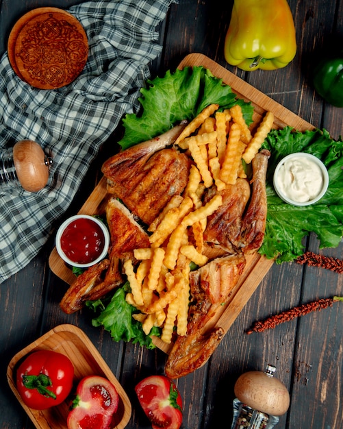 fried chicken with french fries, ketchup, mayonnaise, and lettuce