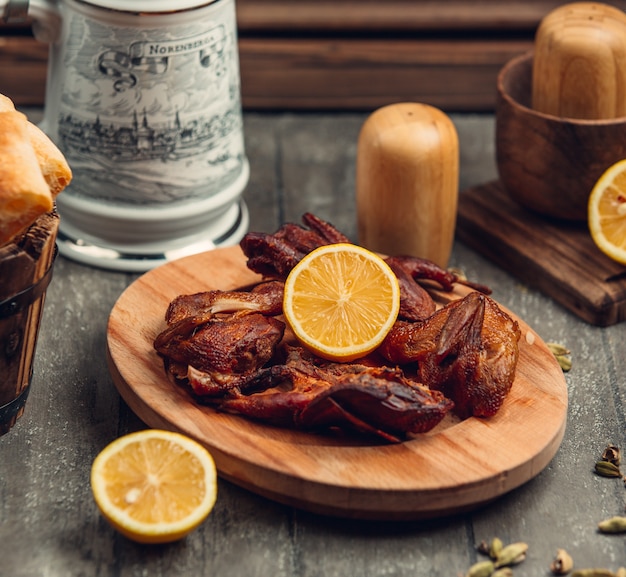 fried chicken with lemon on the wooden board