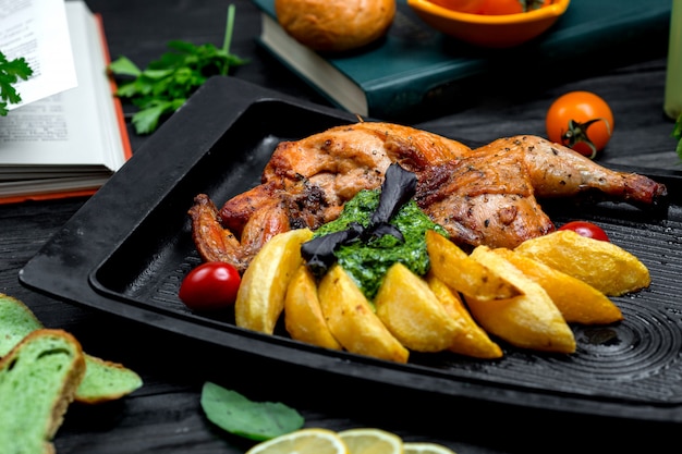 Free photo fried chicken with potatoes on furnace board