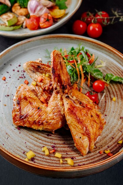 Fried chicken with tomatoes greens and carrots