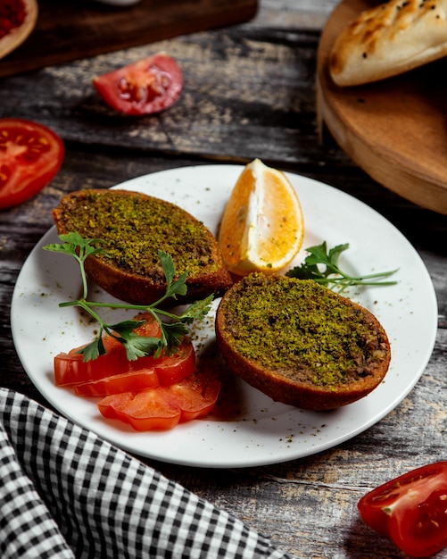 Fried cotletes with green on the table