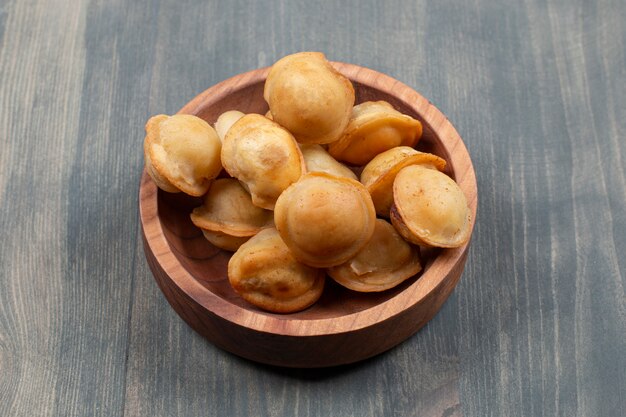 Fried delicious dumplings in a wooden bowl 