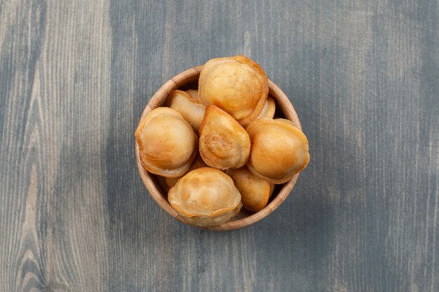 Fried delicious dumplings in a wooden bowl 