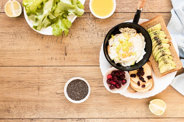 Fried egg in pan with avocado sandwiches