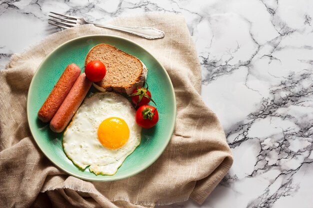 Fried egg with hotdogs and tomatoes