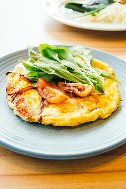 Fried eggs omelette in white plate