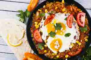 Free photo fried eggs on traditional mexican dish